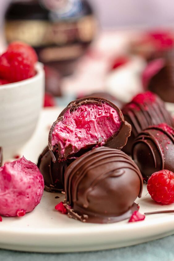 chocolate raspberry truffles with raspberry filling, Truffles stacked on plate One has a bite removed