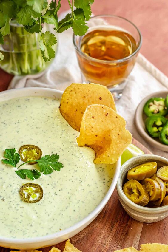 creamy jalapeno ranch dip, Jalapeno ranch dip in a bowl with chips sitting in it