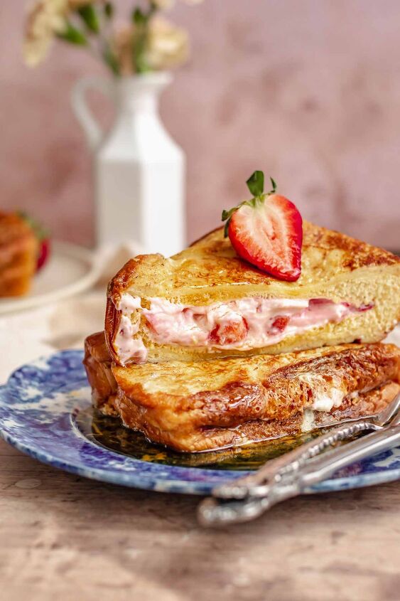 strawberry stuffed french toast, Two stacks of strawberry stuffed French toast on a plate One is cut in half to show the insides