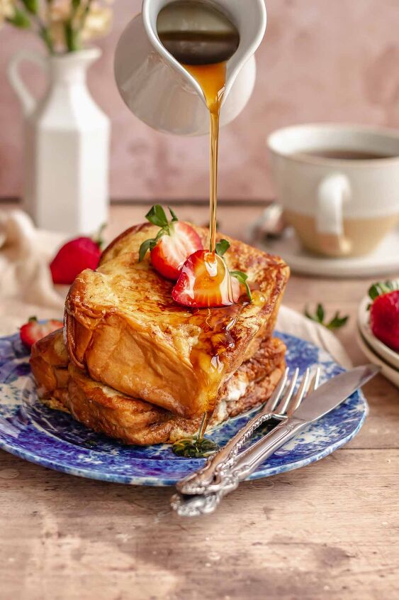 strawberry stuffed french toast, Syrup being poured onto a stack of stuffed French toast