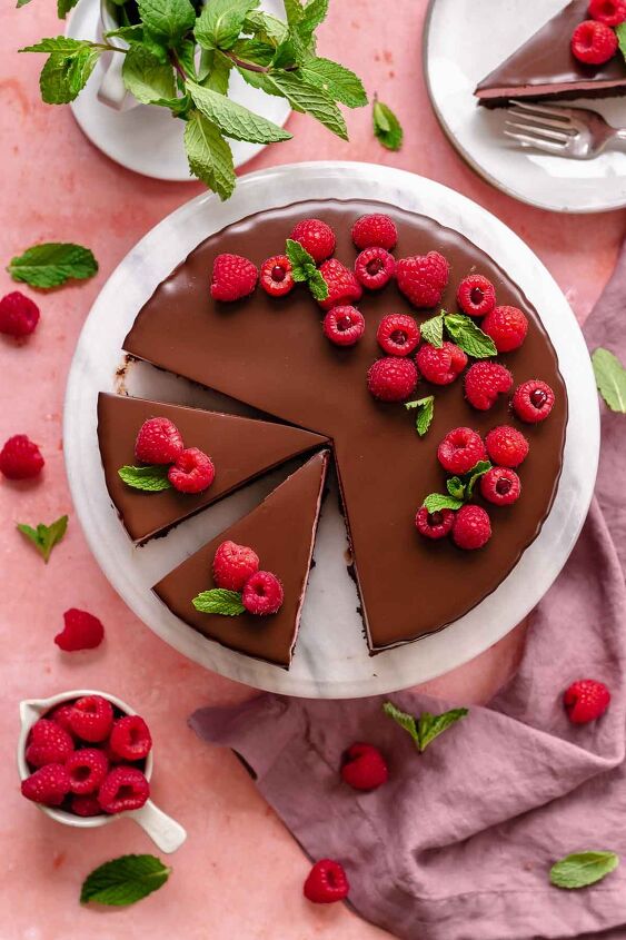chocolate raspberry mousse cake, Chocolate raspberry mousse cake decorated on a platter with slices cut