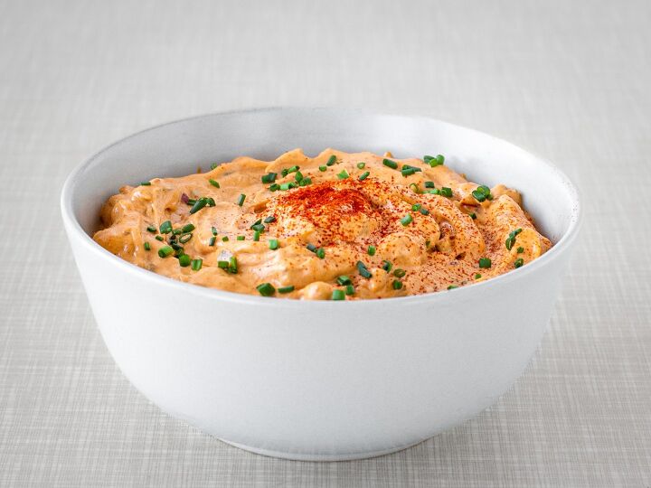 Austrian Liptauer cheese spread in a bowl topped with chives and paprika powder