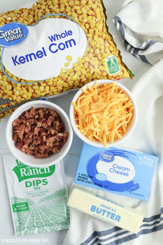 crack corn casserole, A bag of frozen corn crumbled bacon shredded cheese ranch seasoning packets butter and cream cheese sitting on a white counter