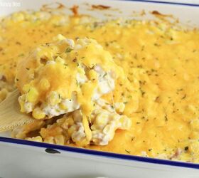 crack corn casserole, A close up of crack corn casserole in a white rectangle with a serving scooped out on a wooden spoon