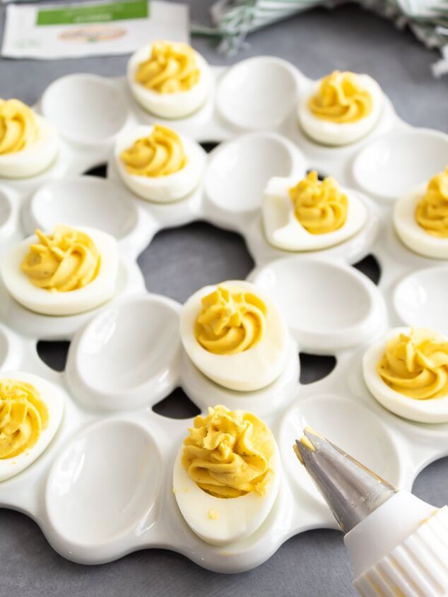 easy deviled eggs two different ways, Piping the ranch deviled egg filling into the egg whites