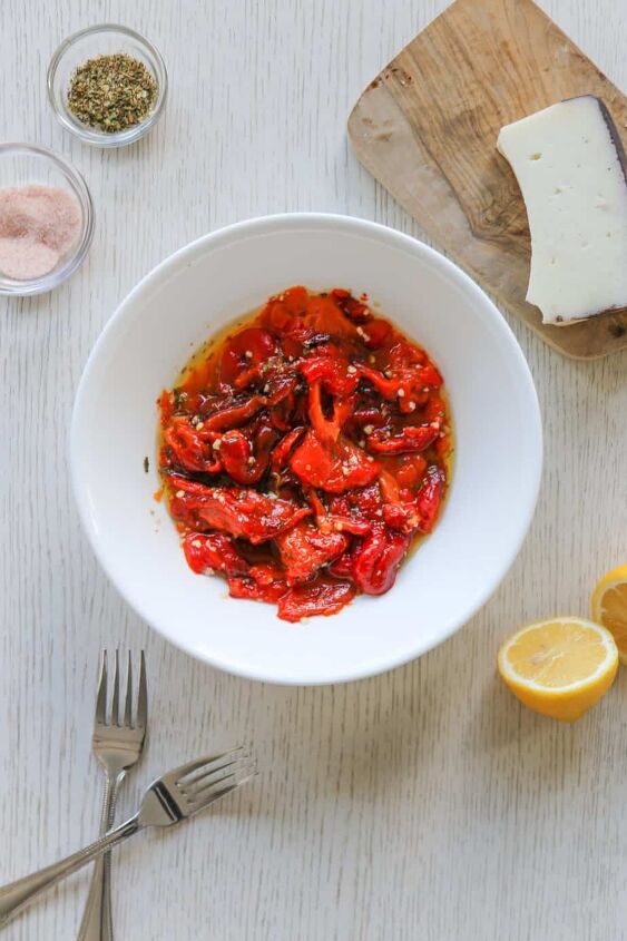 easy vegan italian roasted peppers recipe, bowl of Italian roasted pepper with a fork lemon and cheese