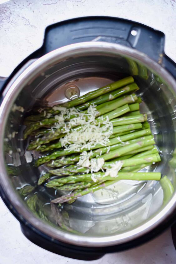 simple steamed instant pot asparagus, Step 1 Cut the asparagus spears so they fit into the Instant Pot Add the olive oil and garlic and mix well Add cup of cold water and close the Instant Pot making sure the lid is set to the sealing position aka the venting position