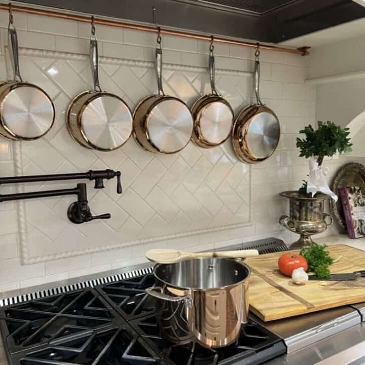 how to make a delicious pear and pecan salad, 15 Beautiful Kitchen Decor Ideas For a Quick Update white tile backsplash copper pots pot filler wooden spoon professional stove wooden cutting board silver urn green plant white satin ribbon copper piping