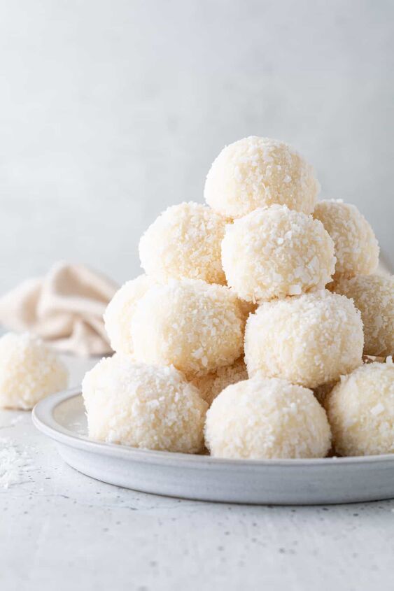 easy no bake coconut balls 2 ingredients, Coconut balls stacked on a small plate