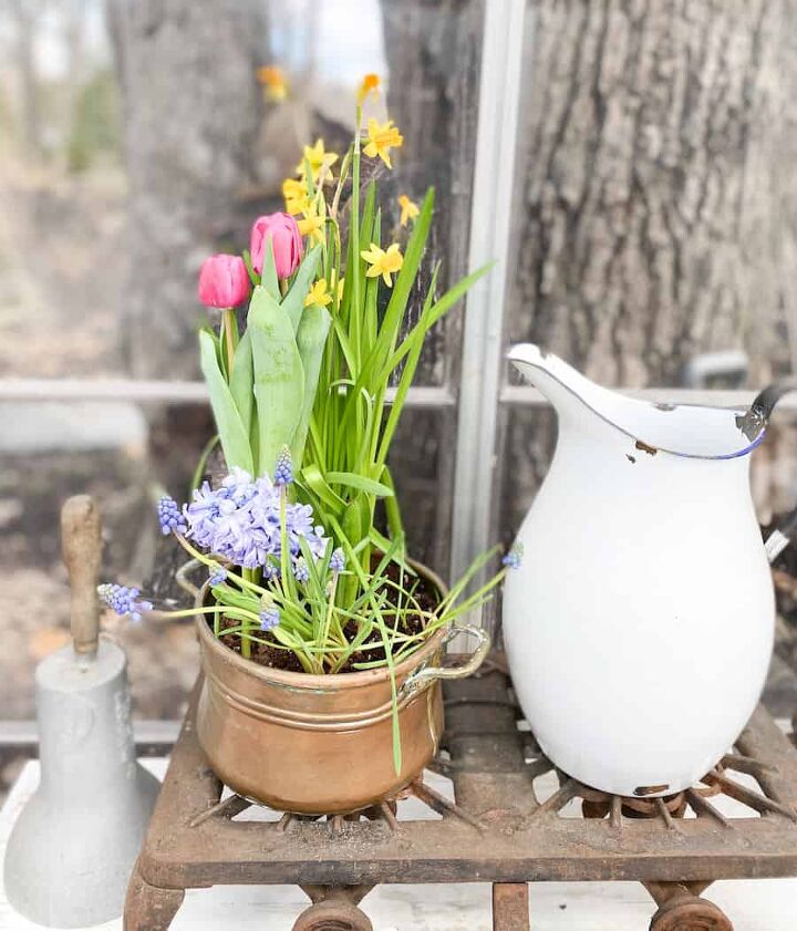 the best menu ideas for easter sunday brunch, spring flowers in a copper post pink tulips yellow daffodils and blue hyacinth