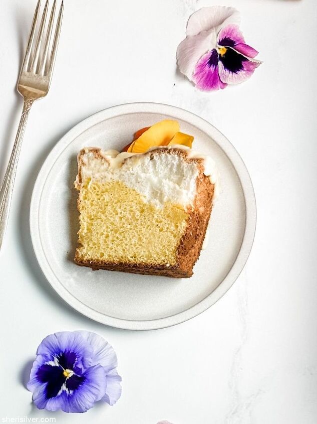 make this daffodil cake recipe for spring, daffodil cake slice on a ceramic plate with edible pansies