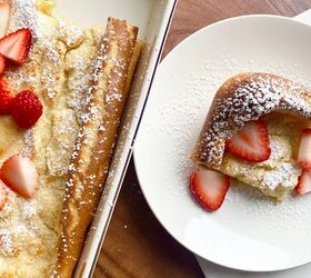 swedish oven pancake, Aerial view of Swedish Pancake in a baking dish with a slice plated on a white plate with sliced strawberries