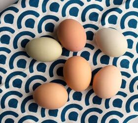 simple deviled eggs, Farm fresh eggs laying on a blue patterned tea towel