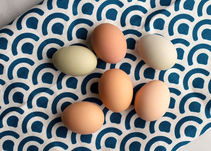simple deviled eggs, Farm fresh eggs laying on a blue patterned tea towel