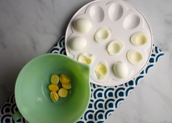 simple deviled eggs, The yolks are in a bowl and the whites on a dish