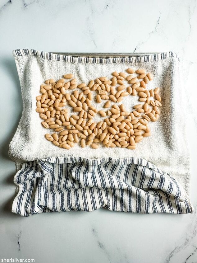 you want to make these crispy roasted white beans, white beans on a striped kitchen towel