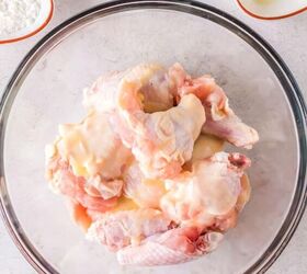 crispy air fryer chicken wings with cornstarch, Raw chicken wings in a bowl with melted butter over the top