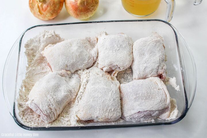 how to make skillet smothered chicken thighs, Chicken thighs in glass baking dish being coated with flour