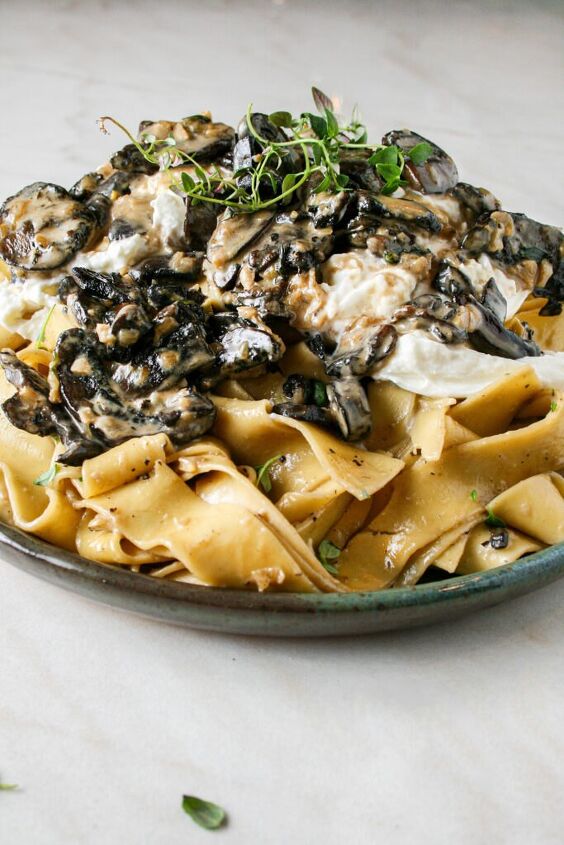 creamy mushroom pasta with burrata, Photograph of Creamy Mushroom Pasta with Burrata pictured on a green plate on top of marble counter top