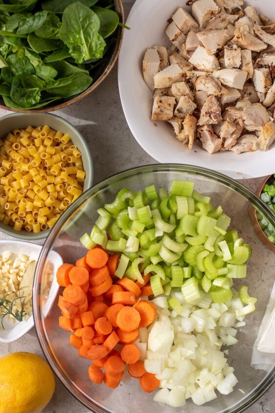 instant pot creamy chicken soup, Ingredients for instant pot creamy chicken soup A big bowl with chopped onions celery and carrot A bowl of fresh spinach a bowl of pasta and a bowl of cooked rotisserie chicken