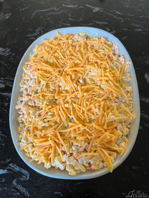 creamy jalapeno corn casserole recipe easy vegetable side dish, Unbaked jalepeno corn casserole mixture in baking dish topped with shredded cheese