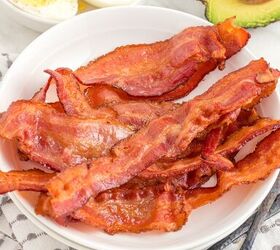 how to cook bacon in the air fryer, bacon on a plate on the table with boiled eggs and avocado