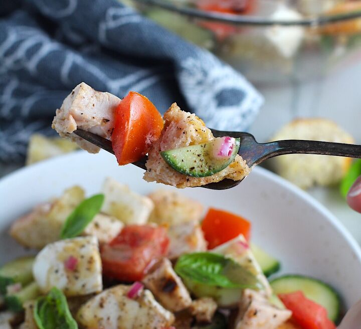 panzanella toscana with chicken and mozzarella, Toasted bread cubes chicken tomatoes cucumber on a fork over a bowl of Chicken Panzanella Salad Recipe It s absolutely delicious