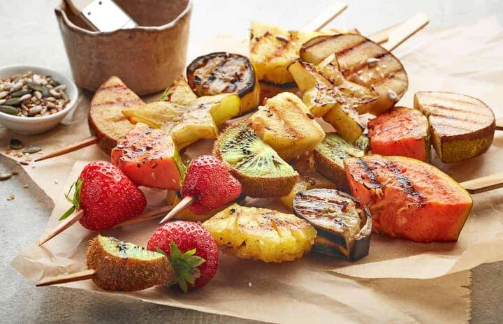 various grilled fruit pieces on wooden skewers
