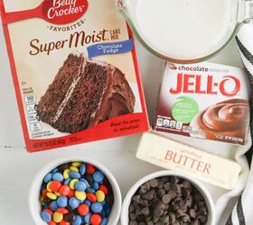 chocolate dump cake recipe with cake mix pudding mix and m ms, All ingredients for chocolate dump cake sitting on a white countertop