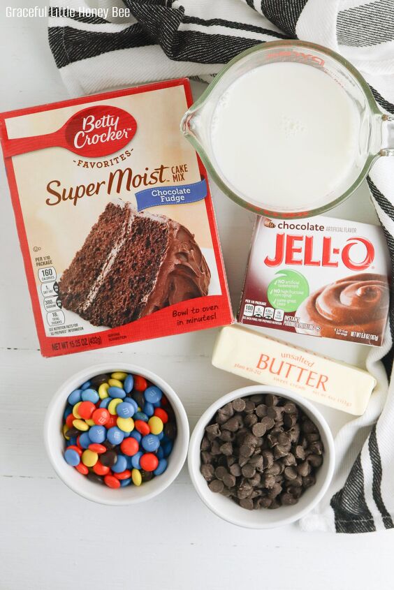chocolate dump cake recipe with cake mix pudding mix and m ms, All ingredients for chocolate dump cake sitting on a white countertop