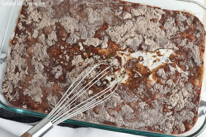 chocolate dump cake recipe with cake mix pudding mix and m ms, Cake mix milk and pudding mix in a glass baking dish with a whisk