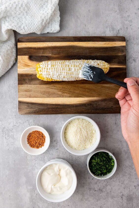 easy mexican street corn recipe to enjoy w summer grilling, Brush toppings on Mexican Street Corn