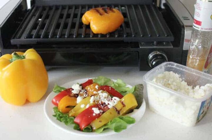 grilled peppers with feta cheese, colorful peppers cut in half in front of a grill