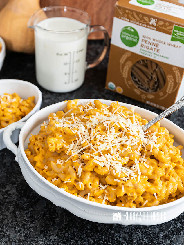 the best healthy mac and cheese recipe, Healthy mac and cheese in a white serving bowl garnished with Parmesan cheese