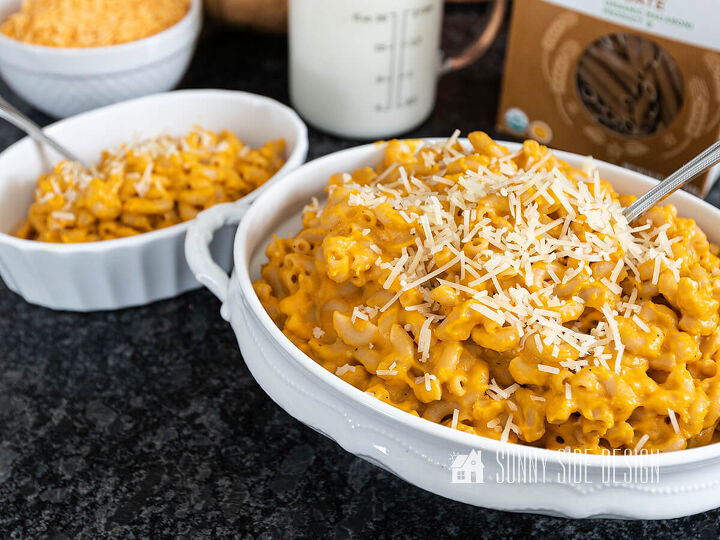 the best healthy mac and cheese recipe, Healthy mac and cheese in a white serving bowl garnished with Parmesan cheese