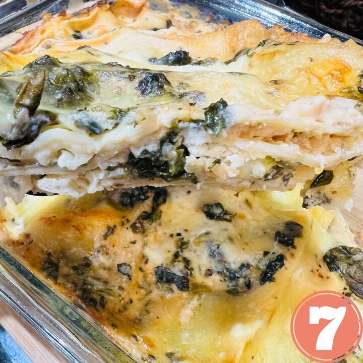 easy meatless white spinach lasagna, A slice of white spinach lasagna on a spatula over a tray of lasagna