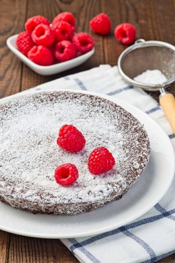 Chocolate cake baked in a round pan Confectioner s sugar sprinkled on top
