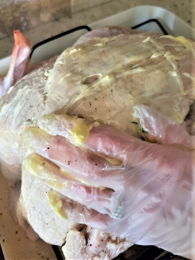 guaranteed easy juicy crispy roast turkey recipe, spreading butter oil mixture on entire turkey for moisture crispy skin