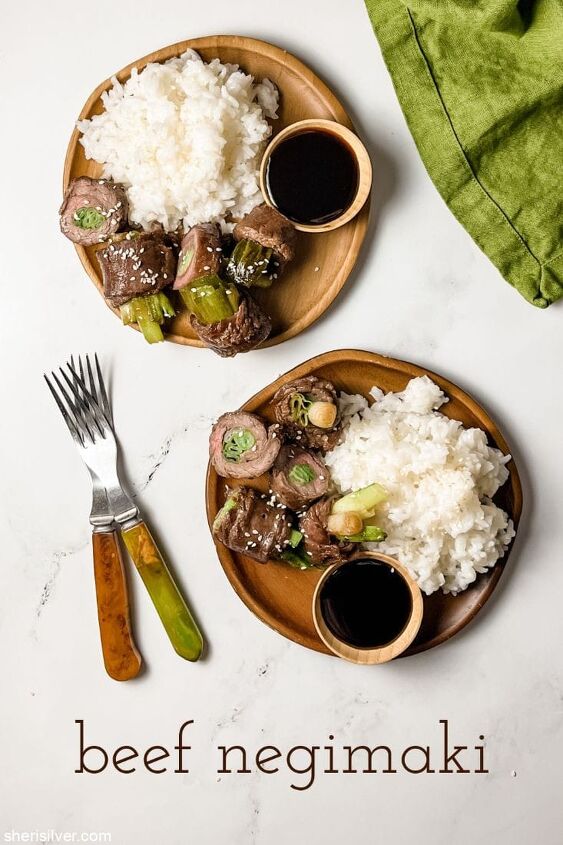 make this easy beef scallion negimaki recipe tonight, beef negimaki with white rice on wooden plates next to a green linen napkin
