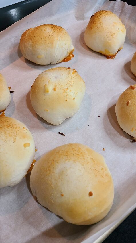 cheesy pizza meatball bombs recipe, Baked and browned meatball bombs on a baking sheet