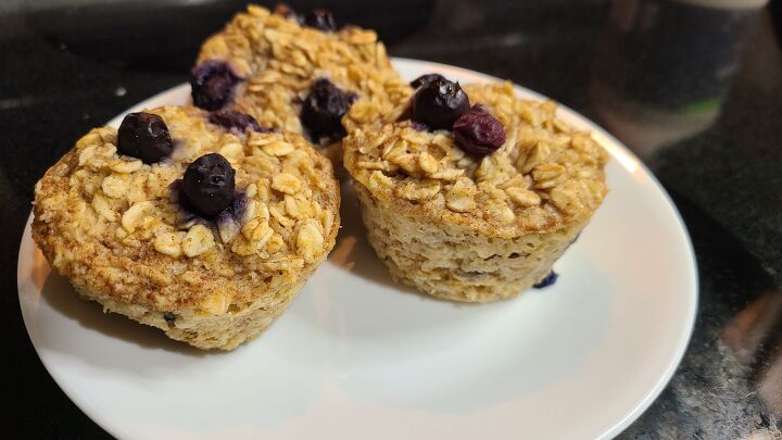 baked blueberry oatmeal cups meal prep friendly, Three blueberry oatmeal cups on a small plate