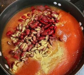budget red beans and rice recipe, A skillet filled with beans tomato sauce and spices