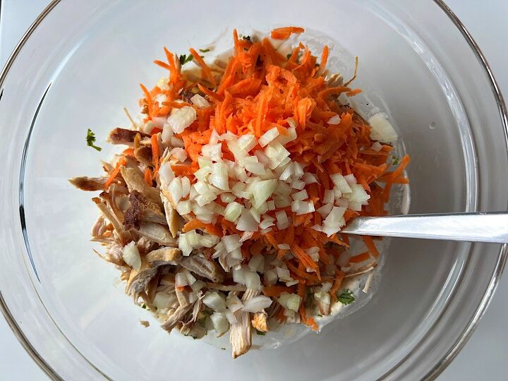 brazilian chicken salad salpicao de frango, Bowl with mayonnaise dressing shredded chicken carrots and onion before being mixed for Brazilian Chicken Salad
