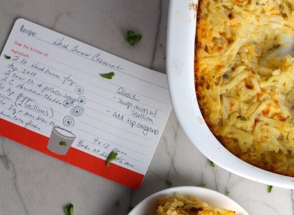 cheesy hash brown casserole without soup, Cheesy Hash Brown Casserole without soup from a can on plate and in casserole dish on counter with recipe card This recipe does not disappoint It s warm creamy and full of flavor And it s the perfect side dish for your holiday dinner