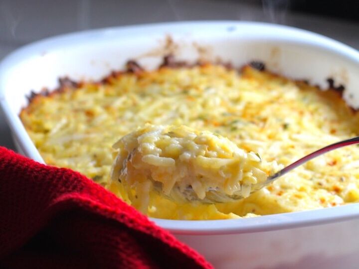cheesy hash brown casserole without soup, holiday side dishes cheesy hash brown casserole with spoon scooping