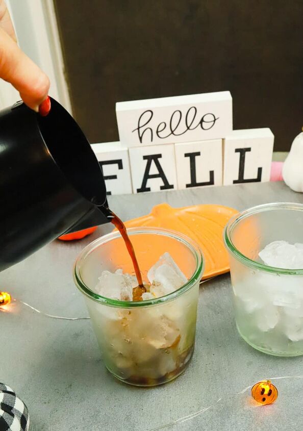pumpkin iced coffee, coffee being poured over glasses of ice
