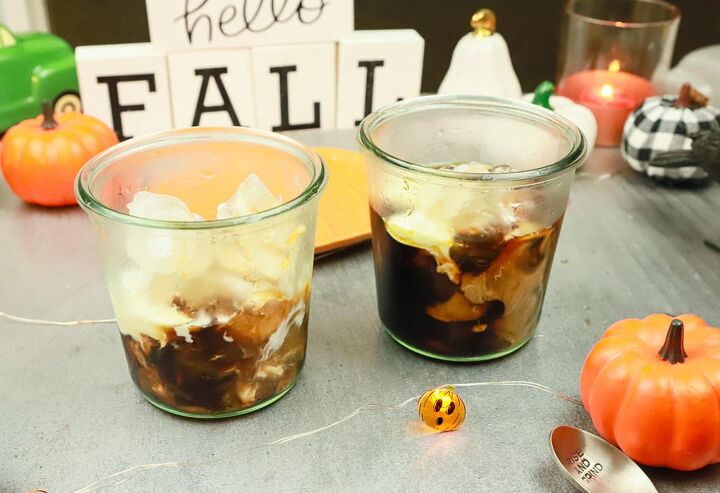 pumpkin iced coffee, heavy cream ice and coffee with a hello fall sign in the background
