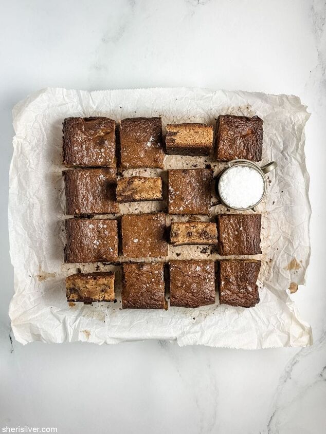 the best miso brown butter chocolate chunk blondies, miso brown butter chocolate chunk blondies on parchment paper with a salt cellar