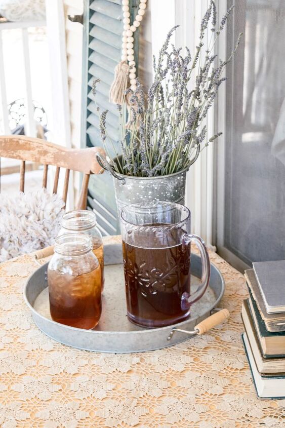 herbal infused iced tea, pitcher of iced tea and 2 mason jars full of tea on a round tray Porch scene
