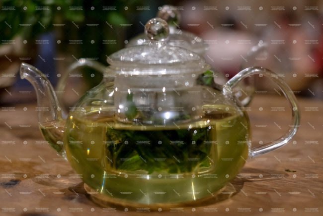 herbal infused iced tea, glass teapot with an herbal infusion